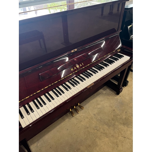 64 - Kawai (c1985)A Model BW 52 upright piano in a traditional bright mahogany case; together with a duet... 