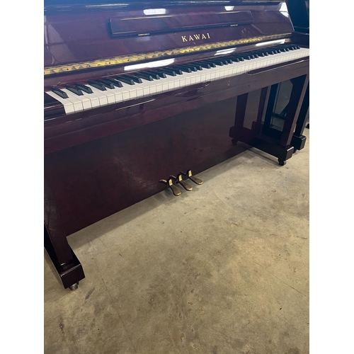 64 - Kawai (c1985)A Model BW 52 upright piano in a traditional bright mahogany case; together with a duet... 