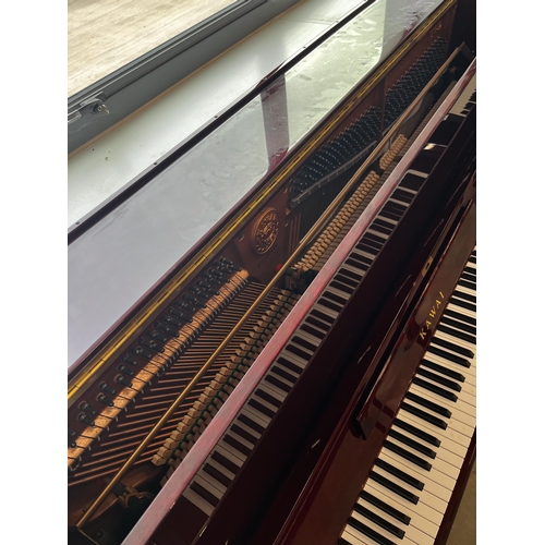 64 - Kawai (c1985)A Model BW 52 upright piano in a traditional bright mahogany case; together with a duet... 