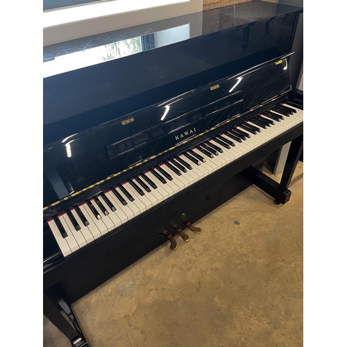 7 - Kawai (c1998)A Model CX-5H upright piano in a bright ebonised case; together with an adjustable stoo... 