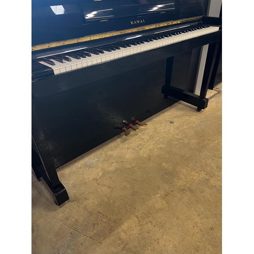 7 - Kawai (c1998)A Model CX-5H upright piano in a bright ebonised case; together with an adjustable stoo... 