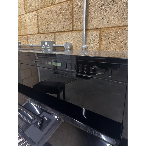 81 - Yamaha (c1991)A Model SX100 RB upright piano in a traditional bright ebonised case with an integral ... 