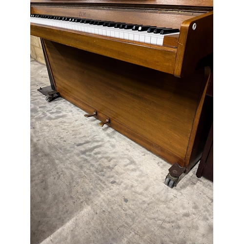 84 - Welmar (c1984)An upright piano in a mahogany case.