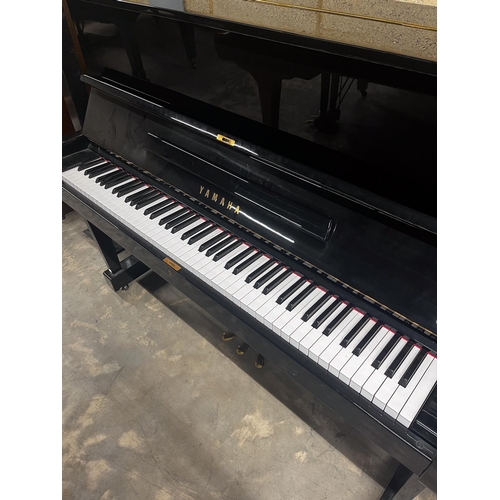 91 - Yamaha (1970)A Model U1 upright piano in a bright ebonised case; together with a stool.