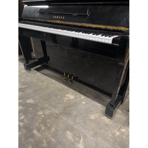 91 - Yamaha (1970)A Model U1 upright piano in a bright ebonised case; together with a stool.