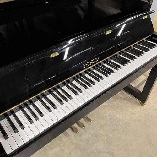 25 - Feurich (c2013)A Model 115 upright piano in a traditional bright ebonised case; together with a stoo... 