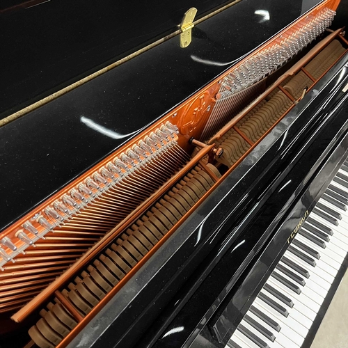 25 - Feurich (c2013)A Model 115 upright piano in a traditional bright ebonised case; together with a stoo... 