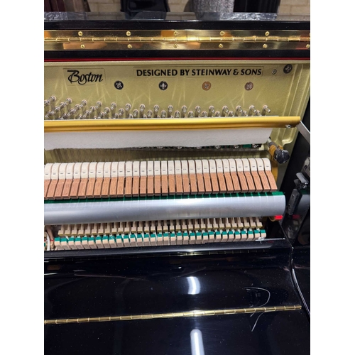 27 - Boston (c2019)A Model UP118 upright piano in a traditional bright ebonised case; together with a mat... 