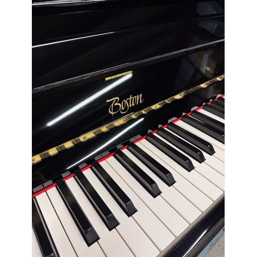 27 - Boston (c2019)A Model UP118 upright piano in a traditional bright ebonised case; together with a mat... 