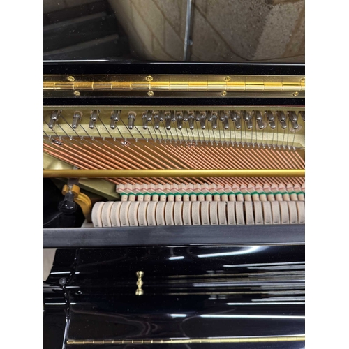 27 - Boston (c2019)A Model UP118 upright piano in a traditional bright ebonised case; together with a mat... 