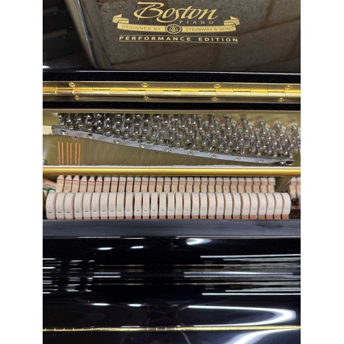 27 - Boston (c2019)A Model UP118 upright piano in a traditional bright ebonised case; together with a mat... 