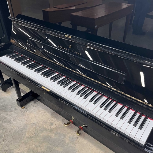 30 - Steinway (c2016)A Model K upright piano in a traditional bright ebonised case.