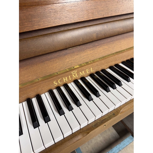 4 - Schimmel (c1993)An upright piano in a traditional satin walnut case; together with a stool.