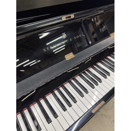 42 - Steinway (c1986)A Model K upright piano in a bright ebonised case.