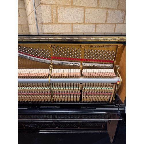 42 - Steinway (c1986)A Model K upright piano in a bright ebonised case.