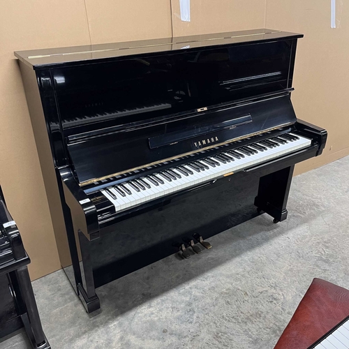 61 - Yamaha (c1973)A Model U2 upright piano in a bright ebonised case; together with a matching stool.... 