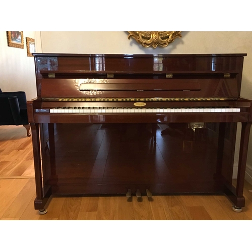 7 - Kemble (c1999)An upright piano in a traditional bright ebonised case; together with a stool.