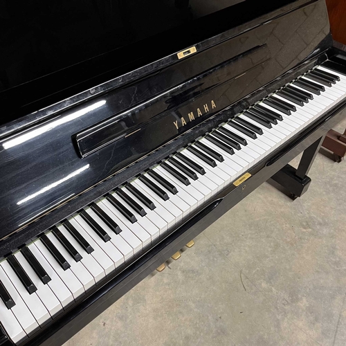 71 - Yamaha (c1975)A Model U1H upright piano in a bright ebonised case; together with a matching stool.... 