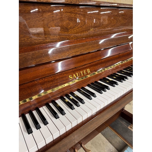 9 - Sauter (c1985)A Model 110 upright piano in a traditional bright mahogany case; together with a stool... 