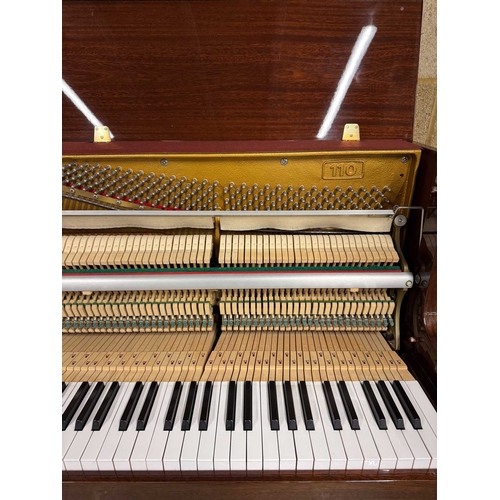 9 - Sauter (c1985)A Model 110 upright piano in a traditional bright mahogany case; together with a stool... 