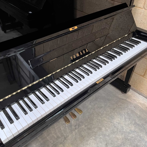 91 - Yamaha (c1982) A Model U3A upright piano in a traditional bright ebonised case.