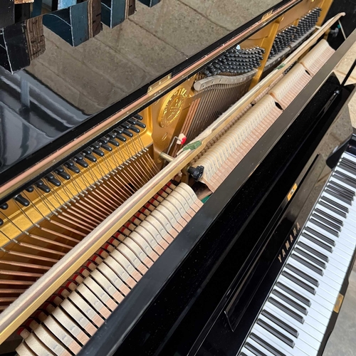 91 - Yamaha (c1982) A Model U3A upright piano in a traditional bright ebonised case.