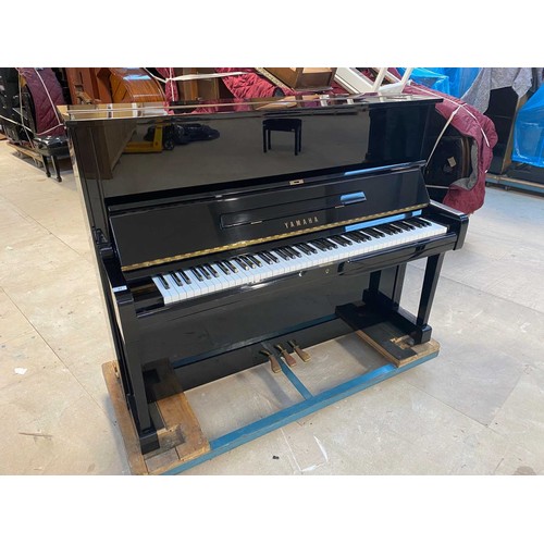 31 - Yamaha (c1985)A Model U1 upright piano in a traditional bright ebonised case; together with a matchi... 