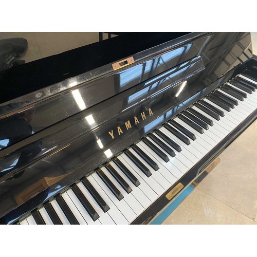 31 - Yamaha (c1985)A Model U1 upright piano in a traditional bright ebonised case; together with a matchi... 