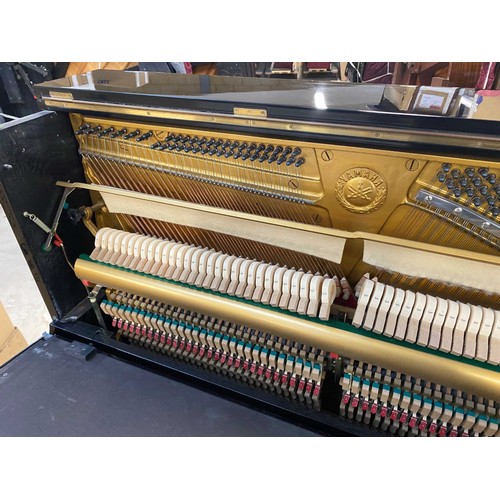 31 - Yamaha (c1985)A Model U1 upright piano in a traditional bright ebonised case; together with a matchi... 