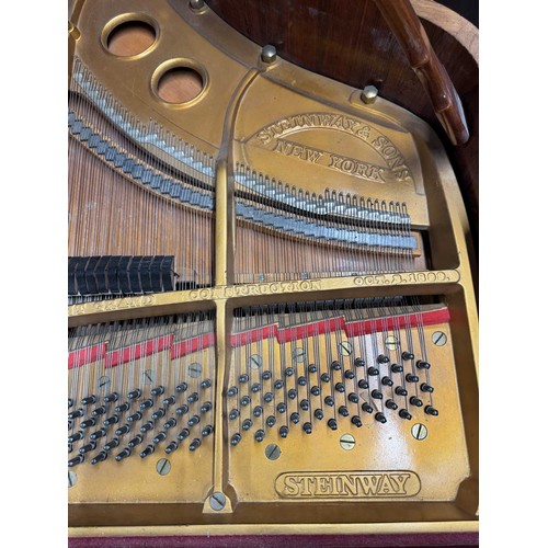 5 - Steinway (c1922)A 5ft 10in Model O grand piano in a rosewood case on square tapered legs; together w... 