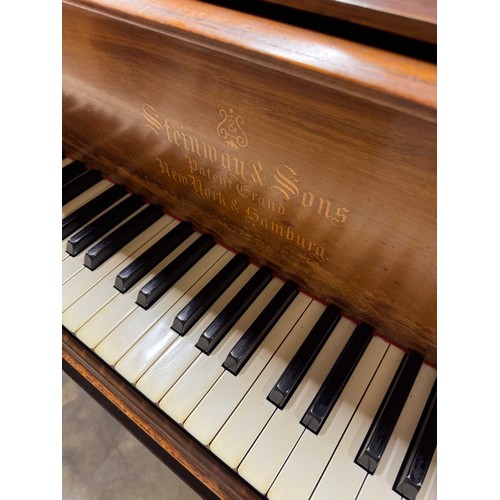 14 - Steinway (c1912)A 6ft 11in Model B grand piano in a rosewood case on square tapered legs; together w... 