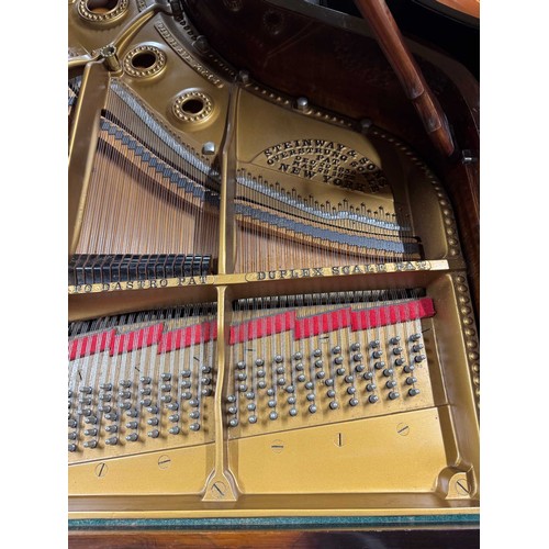 14 - Steinway (c1912)A 6ft 11in Model B grand piano in a rosewood case on square tapered legs; together w... 