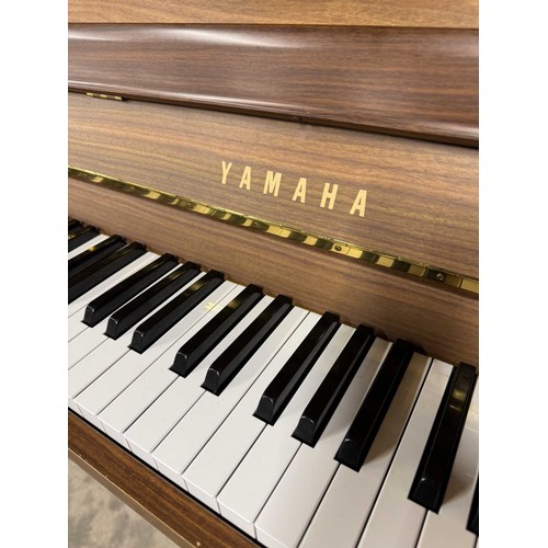 15 - Yamaha (c1996)A Model E108 upright piano in a walnut case; once the property of Paul Arthurs of Oasi... 