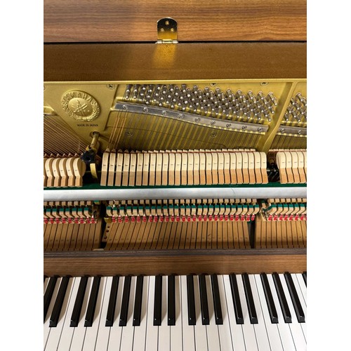 15 - Yamaha (c1996)A Model E108 upright piano in a walnut case; once the property of Paul Arthurs of Oasi... 