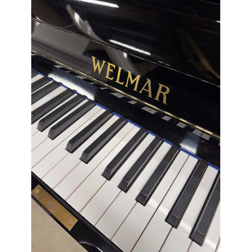 17 - Welmar (c1987)A Model 126 upright piano in a bright ebonised case.