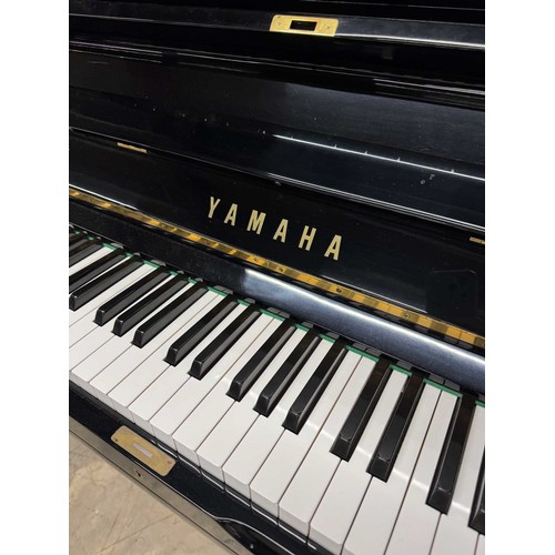 21 - Yamaha (c1977)A Model U3H upright piano in a traditional bright ebonised case.