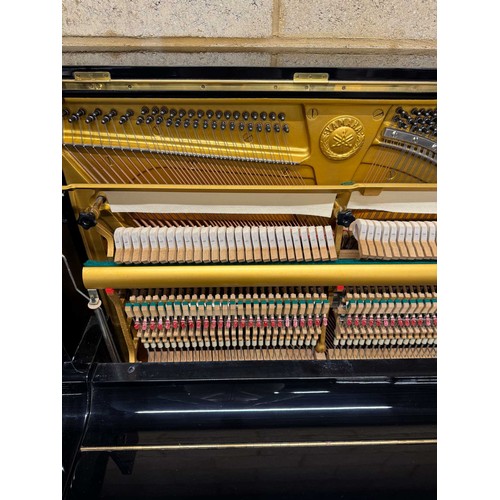 21 - Yamaha (c1977)A Model U3H upright piano in a traditional bright ebonised case.