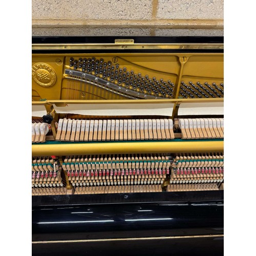 21 - Yamaha (c1977)A Model U3H upright piano in a traditional bright ebonised case.