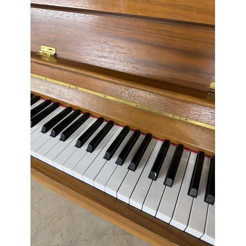 33 - AstorA recent modern upright piano in a walnut case.