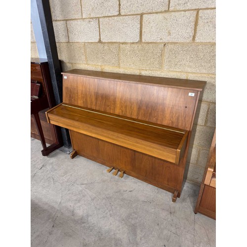 33 - AstorA recent modern upright piano in a walnut case.