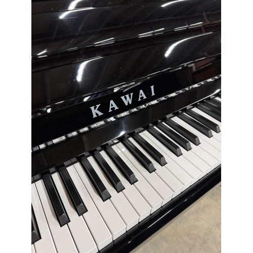 37 - Kawai (c2020)An upright piano in a bright ebonised case.