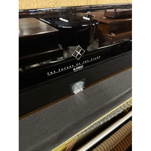 37 - Kawai (c2020)An upright piano in a bright ebonised case.