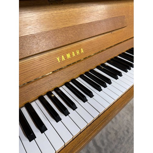 46 - *Yamaha (c1976)An upright piano in a modern style teak case. There is VAT on this Lot.