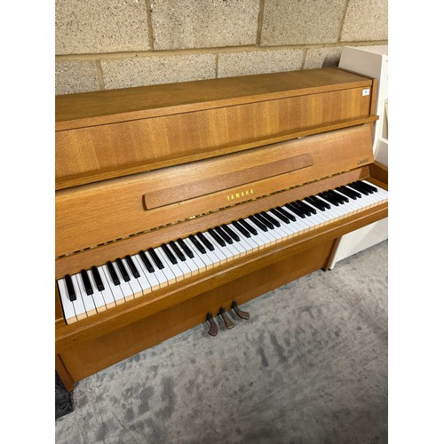 46 - *Yamaha (c1976)An upright piano in a modern style teak case. There is VAT on this Lot.