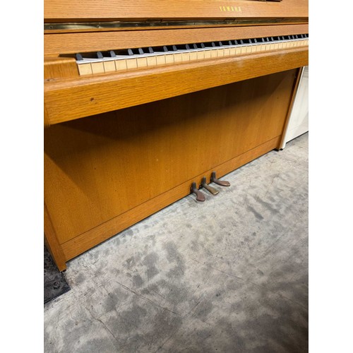 46 - *Yamaha (c1976)An upright piano in a modern style teak case. There is VAT on this Lot.