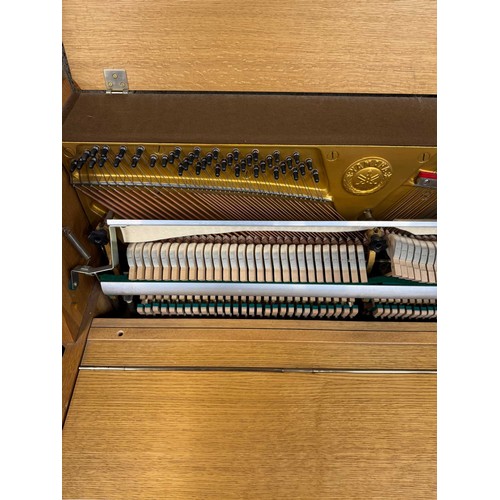 46 - *Yamaha (c1976)An upright piano in a modern style teak case. There is VAT on this Lot.