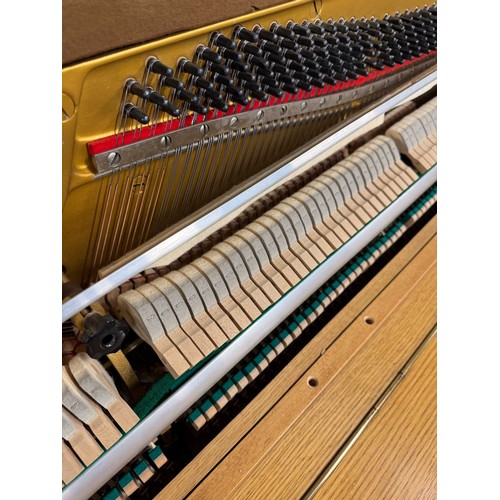 46 - *Yamaha (c1976)An upright piano in a modern style teak case. There is VAT on this Lot.