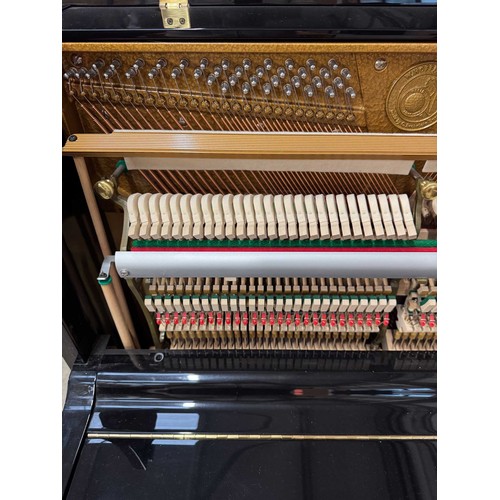 47 - Hoffmann (c2010)A 125cm upright piano in a traditional bright ebonised case; together with a matchin... 