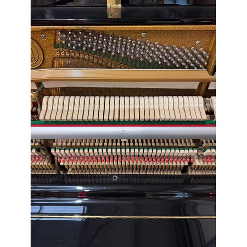 47 - Hoffmann (c2010)A 125cm upright piano in a traditional bright ebonised case; together with a matchin... 