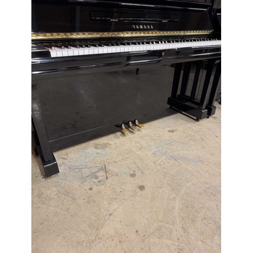 51 - Yamaha (c1977)A Model U1 upright piano in a bright ebonised case; together with a stool. AMENDMENT I... 